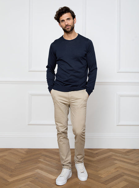 Man wearing midnight blue/grey long sleeved knit in 100% merino wool from New Zealand.